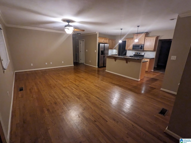 2128 Rockland Dr, Hoover, AL 35226 - kitchen featuring stainless steel appliances, a kitchen breakfast bar, open floor plan, dark wood finished floors, and crown molding