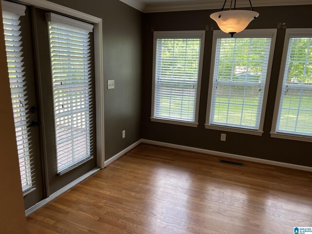 2128 Rockland Dr, Hoover, AL 35226 - unfurnished dining area with healthy amount of natural light, wood finished floors, baseboards, and ornamental molding
