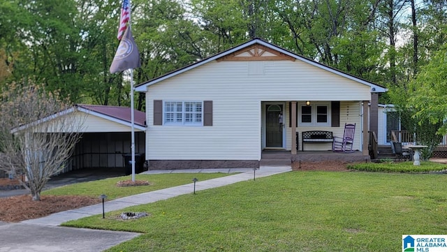 bungalow-style home with a front yard, a detached carport, and covered porch
