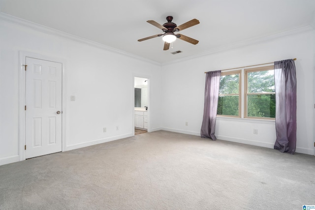 unfurnished bedroom featuring crown molding, carpet floors, baseboards, and visible vents