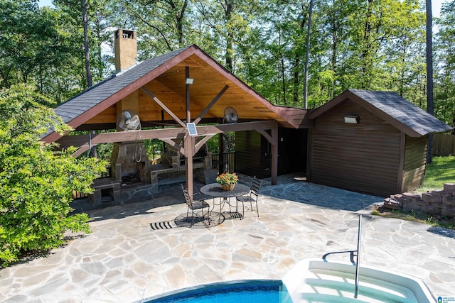 view of swimming pool with a gazebo, a patio area, and a fireplace