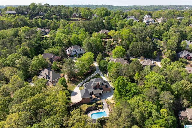 drone / aerial view featuring a residential view and a wooded view