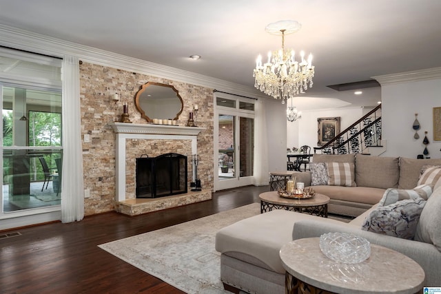 living room with a notable chandelier, a large fireplace, wood finished floors, visible vents, and stairway
