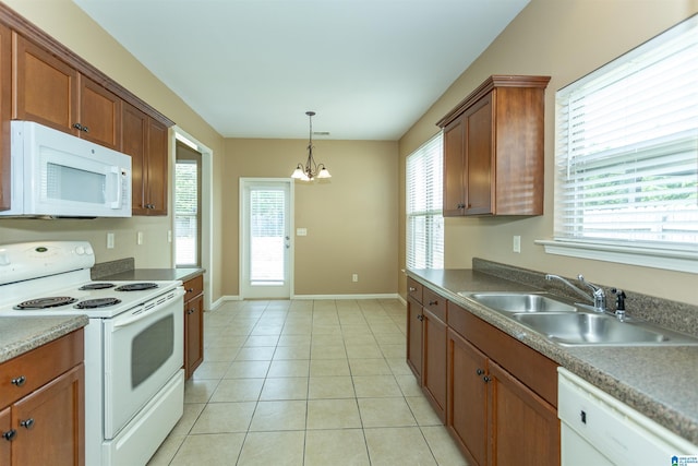 1127 Avalon Dr, Moody, AL 35004 - kitchen with an inviting chandelier, white appliances, brown cabinets, a sink, and baseboards