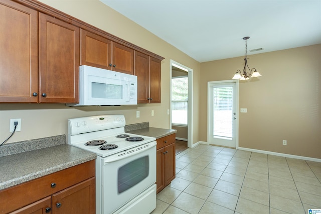 1127 Avalon Dr, Moody, AL 35004 - kitchen with visible vents, brown cabinets, white appliances, and a chandelier