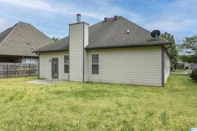 1127 Avalon Dr, Moody, AL 35004 - back of house with roof with shingles, a yard, a chimney, and fence