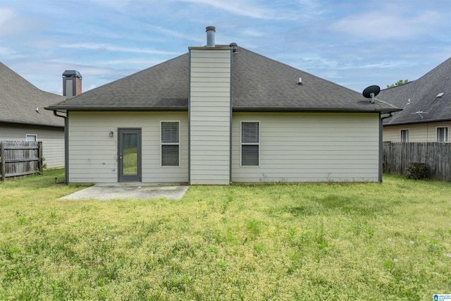 1127 Avalon Dr, Moody, AL 35004 - back of house featuring a patio, roof with shingles, a lawn, and fence