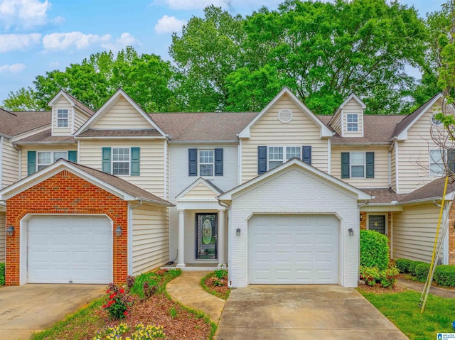 view of property with brick siding and concrete driveway
