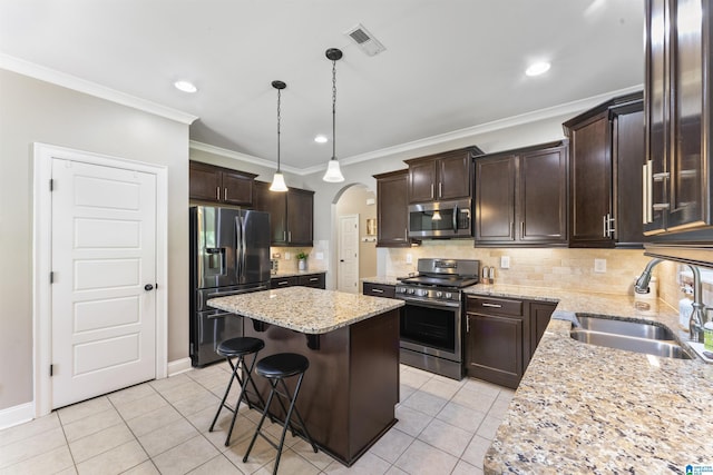 1104 Norman Way, Birmingham, AL 35242 - kitchen featuring visible vents, a center island, arched walkways, a sink, and stainless steel appliances