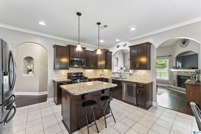 1104 Norman Way, Birmingham, AL 35242 - kitchen featuring visible vents, dark brown cabinets, light tile patterned floors, a sink, and stainless steel appliances