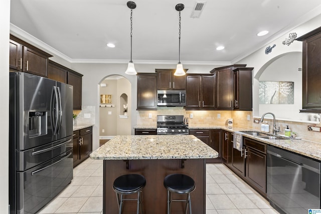 1104 Norman Way, Birmingham, AL 35242 - kitchen with a center island, arched walkways, a sink, light tile patterned floors, and stainless steel appliances