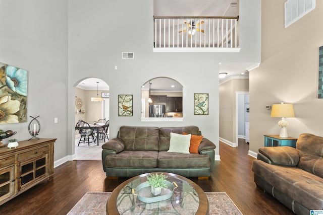 1104 Norman Way, Birmingham, AL 35242 - living room featuring crown molding, a high ceiling, arched walkways, baseboards, and visible vents