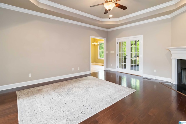 131 Creekwater St, Helena, AL 35080 - unfurnished living room with crown molding, a tray ceiling, dark wood-style floors, a fireplace, and ceiling fan with notable chandelier