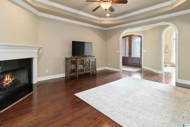 131 Creekwater St, Helena, AL 35080 - living room with a raised ceiling, ceiling fan, a lit fireplace, arched walkways, and wood finished floors