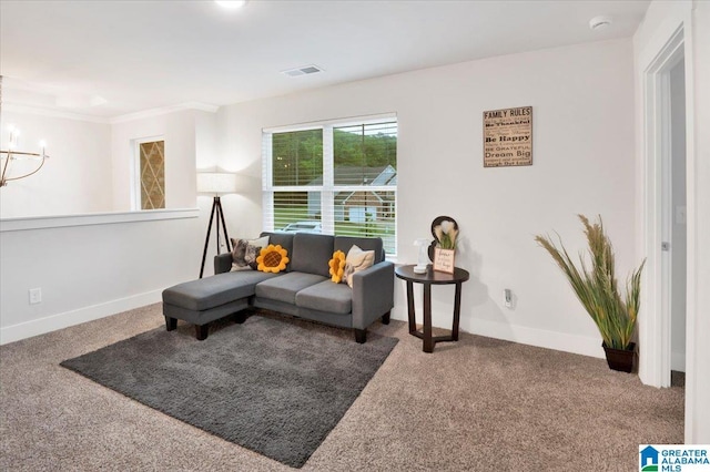 carpeted living area with an inviting chandelier, visible vents, ornamental molding, and baseboards