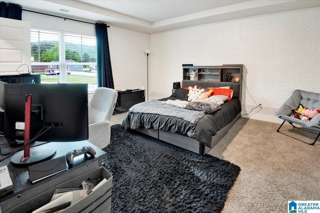 bedroom featuring brick wall