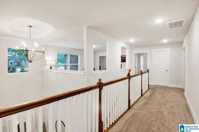 corridor with recessed lighting, a chandelier, visible vents, carpet, and baseboards