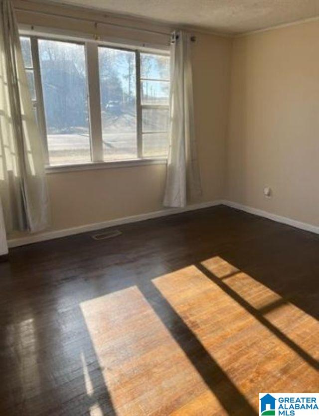 1808 Jefferson Ave, Birmingham, AL 35211 - empty room with wood finished floors and a textured ceiling