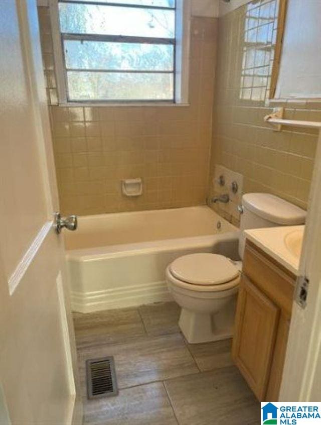 1808 Jefferson Ave, Birmingham, AL 35211 - full bath featuring vanity, wood finished floors, bathtub / shower combination, and tile walls