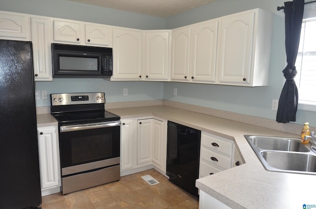 kitchen featuring white cabinetry, black appliances, light countertops, and a sink