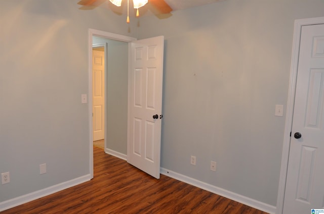 unfurnished bedroom with dark wood-style floors and baseboards