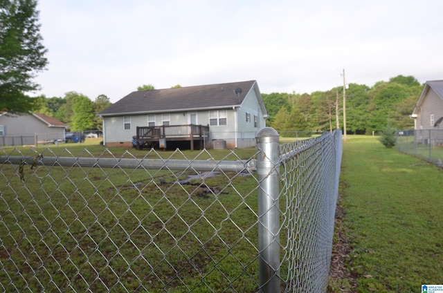 view of yard with a deck and fence