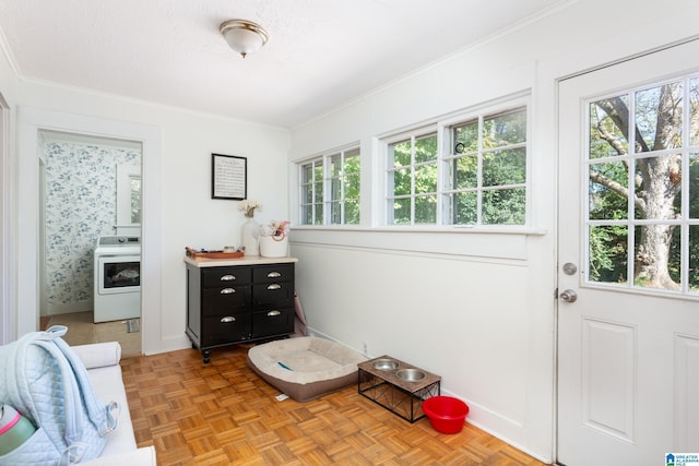 doorway to outside with baseboards, ornamental molding, and a wealth of natural light