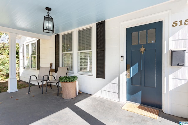 view of exterior entry with a porch