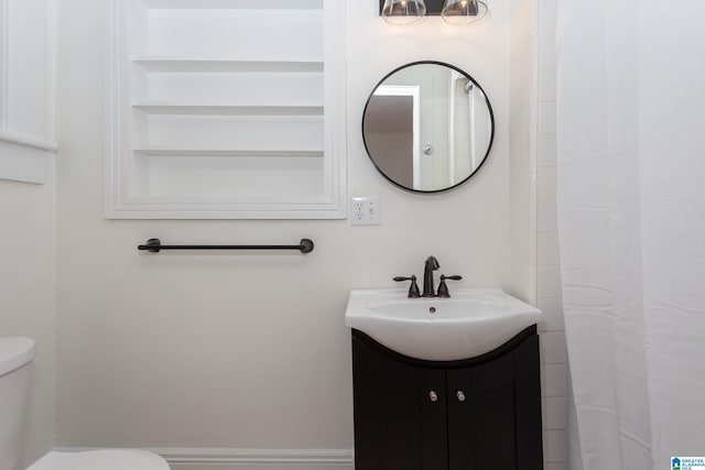 bathroom featuring toilet and vanity