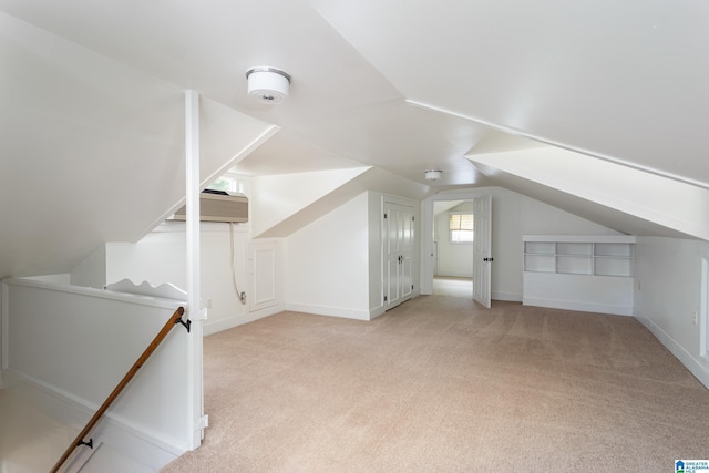 bonus room with baseboards, a wall unit AC, carpet, and vaulted ceiling
