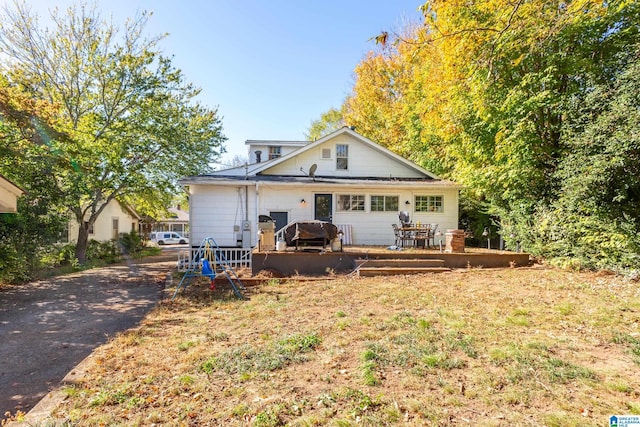 back of house with a deck