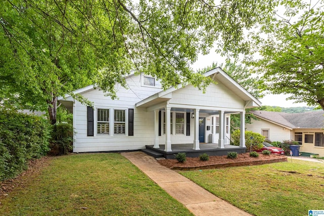 view of front of home featuring a porch and a front lawn