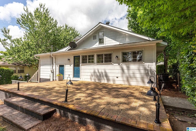 back of property with a wooden deck