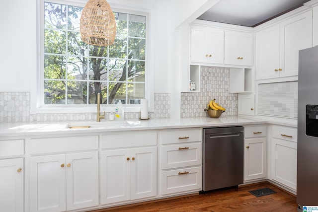 kitchen featuring an inviting chandelier, decorative backsplash, white cabinetry, light countertops, and appliances with stainless steel finishes