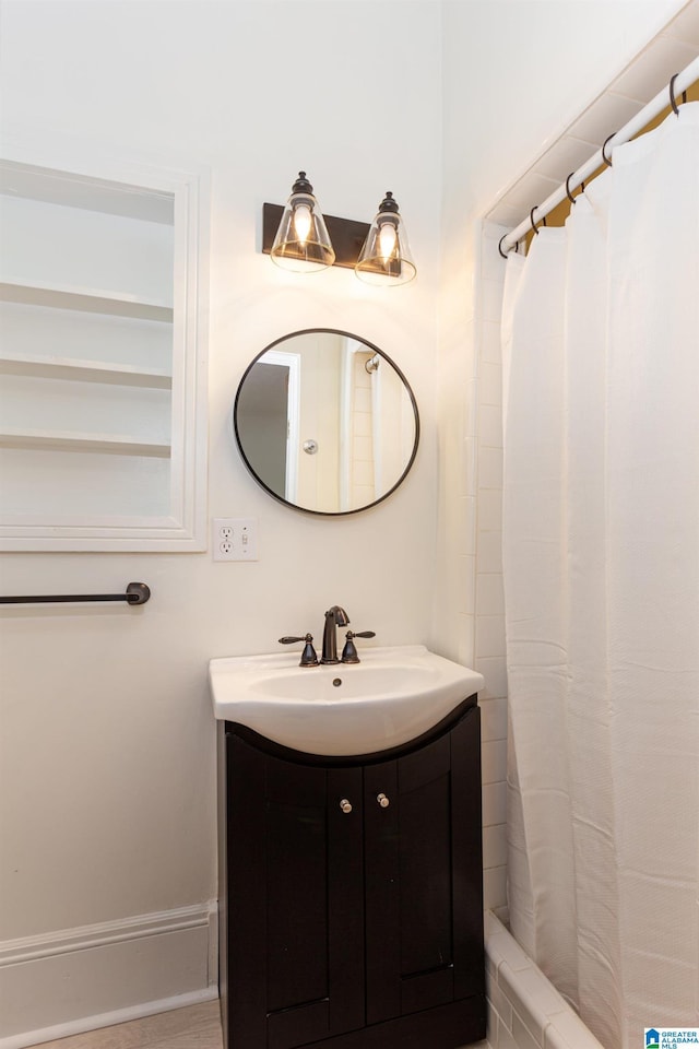full bathroom with a shower with curtain and vanity