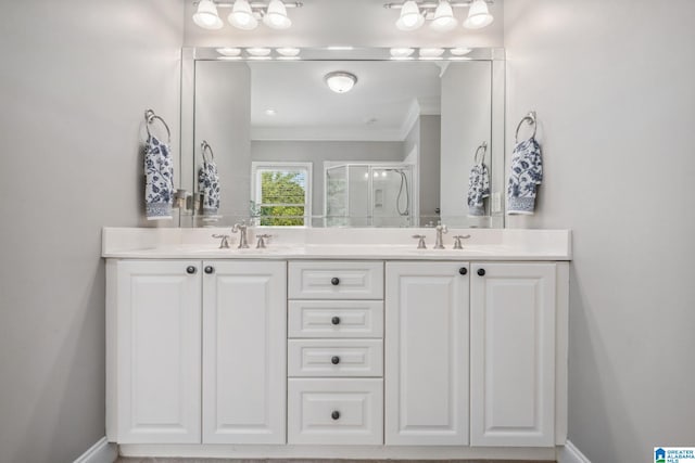 bathroom with crown molding, a sink, double vanity, and a shower stall