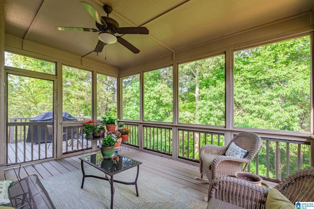 sunroom / solarium featuring ceiling fan