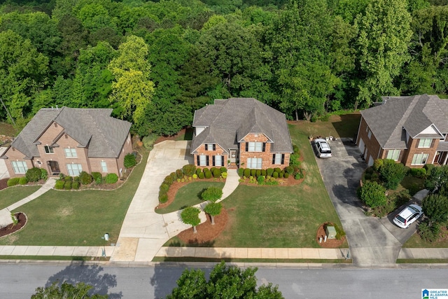 birds eye view of property with a forest view