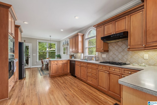 kitchen featuring gas cooktop, freestanding refrigerator, black dishwasher, under cabinet range hood, and ornamental molding