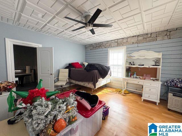bedroom with ceiling fan and light wood-style flooring