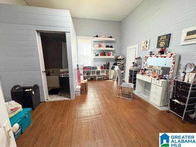 interior space featuring wood finished floors and wooden walls