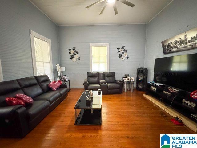 living room with ceiling fan and wood finished floors