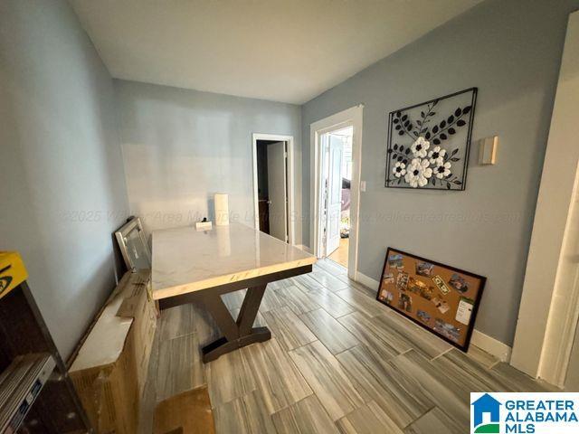 dining space featuring wood finish floors and baseboards