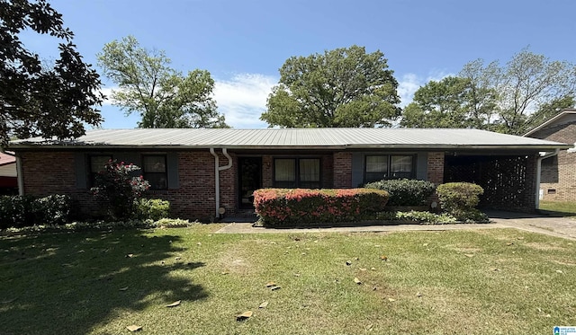 ranch-style house with a front lawn, a carport, concrete driveway, and brick siding