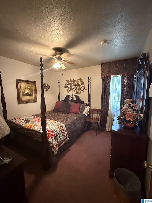 carpeted bedroom with a textured ceiling and ceiling fan