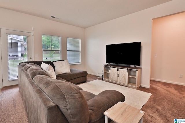 carpeted living area with visible vents and baseboards