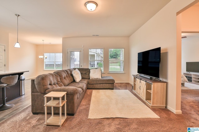 living room featuring carpet, visible vents, and baseboards