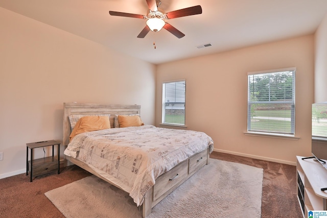 carpeted bedroom with visible vents, ceiling fan, and baseboards