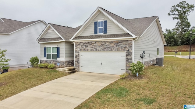 craftsman house featuring concrete driveway, a front yard, a shingled roof, and stone siding