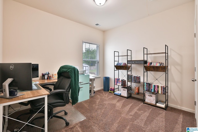 carpeted office space with baseboards and visible vents